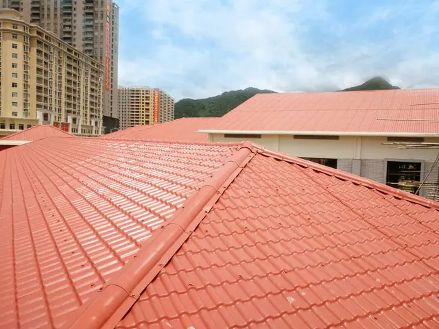 Red profiled roofing sheets installed on buildings